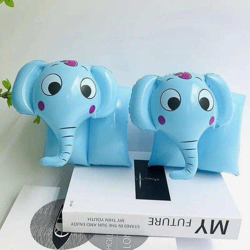 pływaczki do kąpieli w kształcie słoni postawione na białej książce